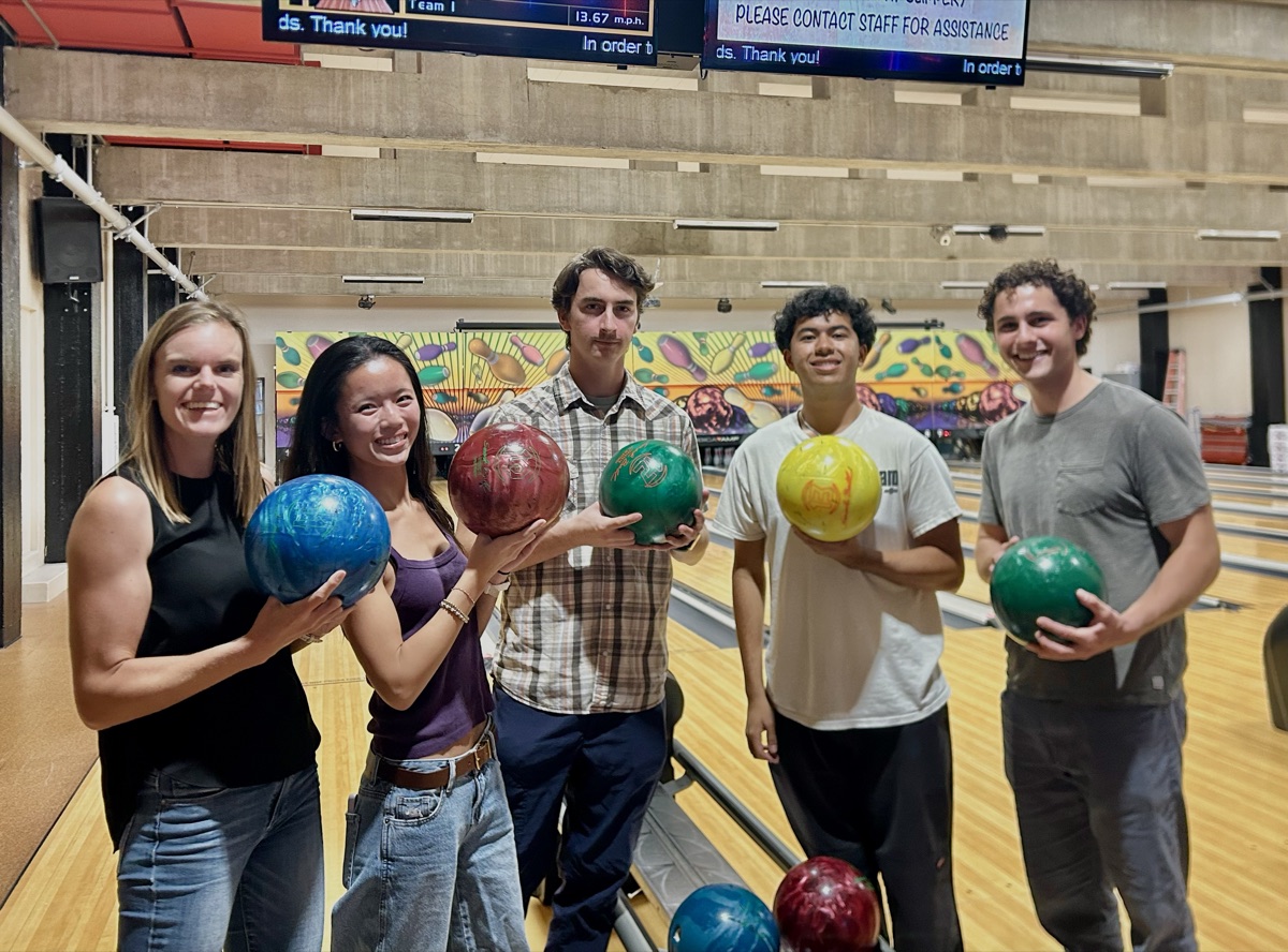 Dann Lab members holding bowling balls during a summer outing