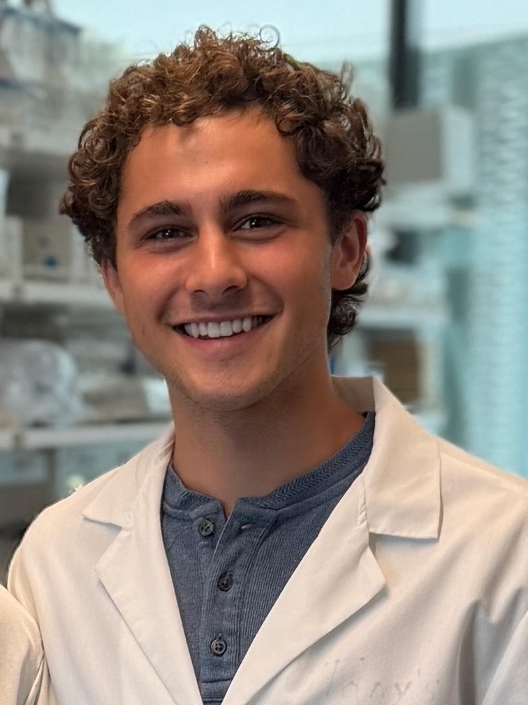Roman A. wearing a lab coat in the laboratory